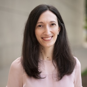 A photo of a smiling woman with shoulder-length dark hair.